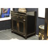 antique Chinese Qing period cabinet in black lacquered wood with typical mountings