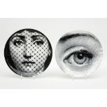 pair of plates in porcelain with a decor after Fornasetti