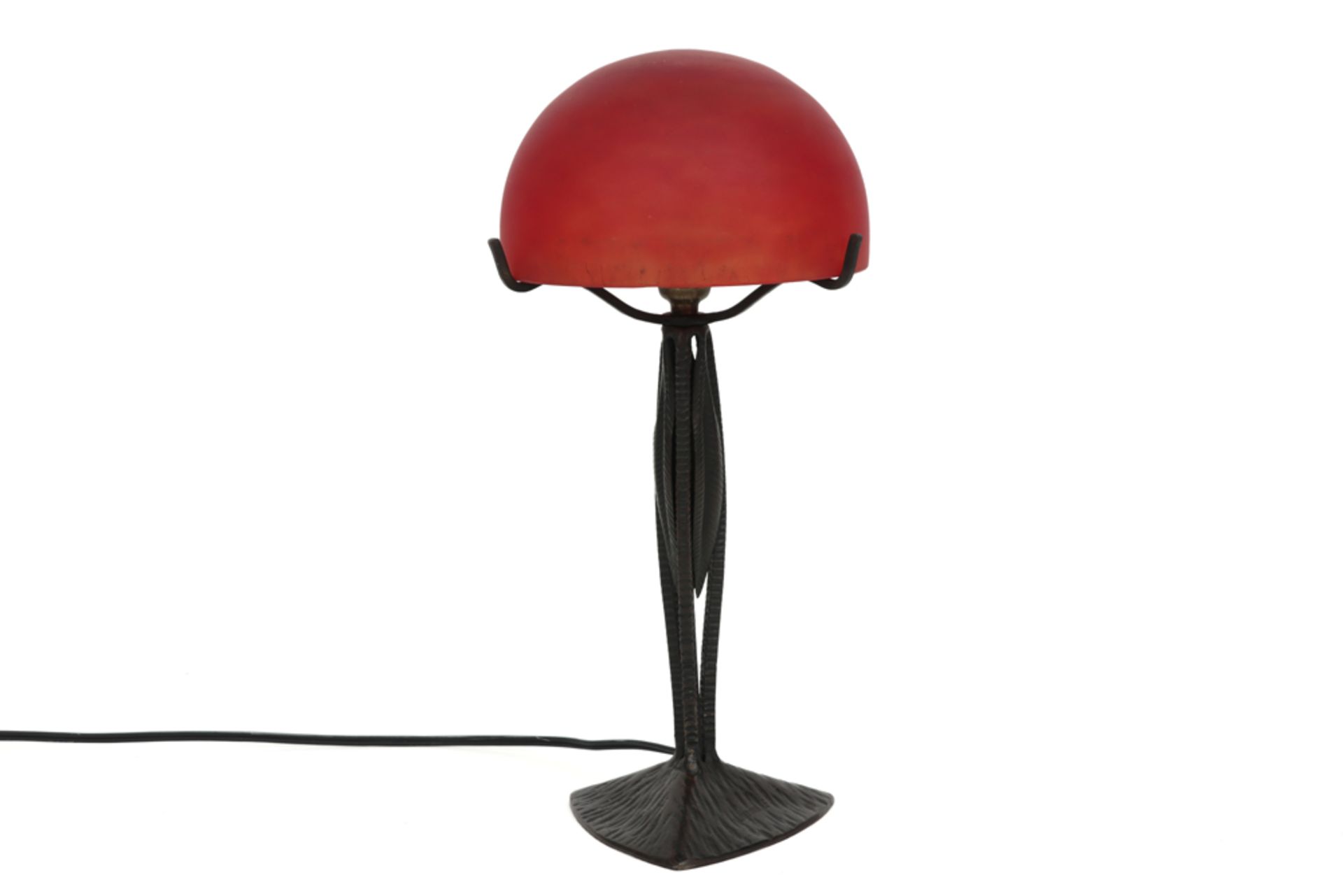Le Fer forgé H.F. marked Art Deco lamp in wrought iron and with red glass shade