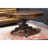 19th Cent. table in mahogany with an oval extendable top on a central quadrupal base