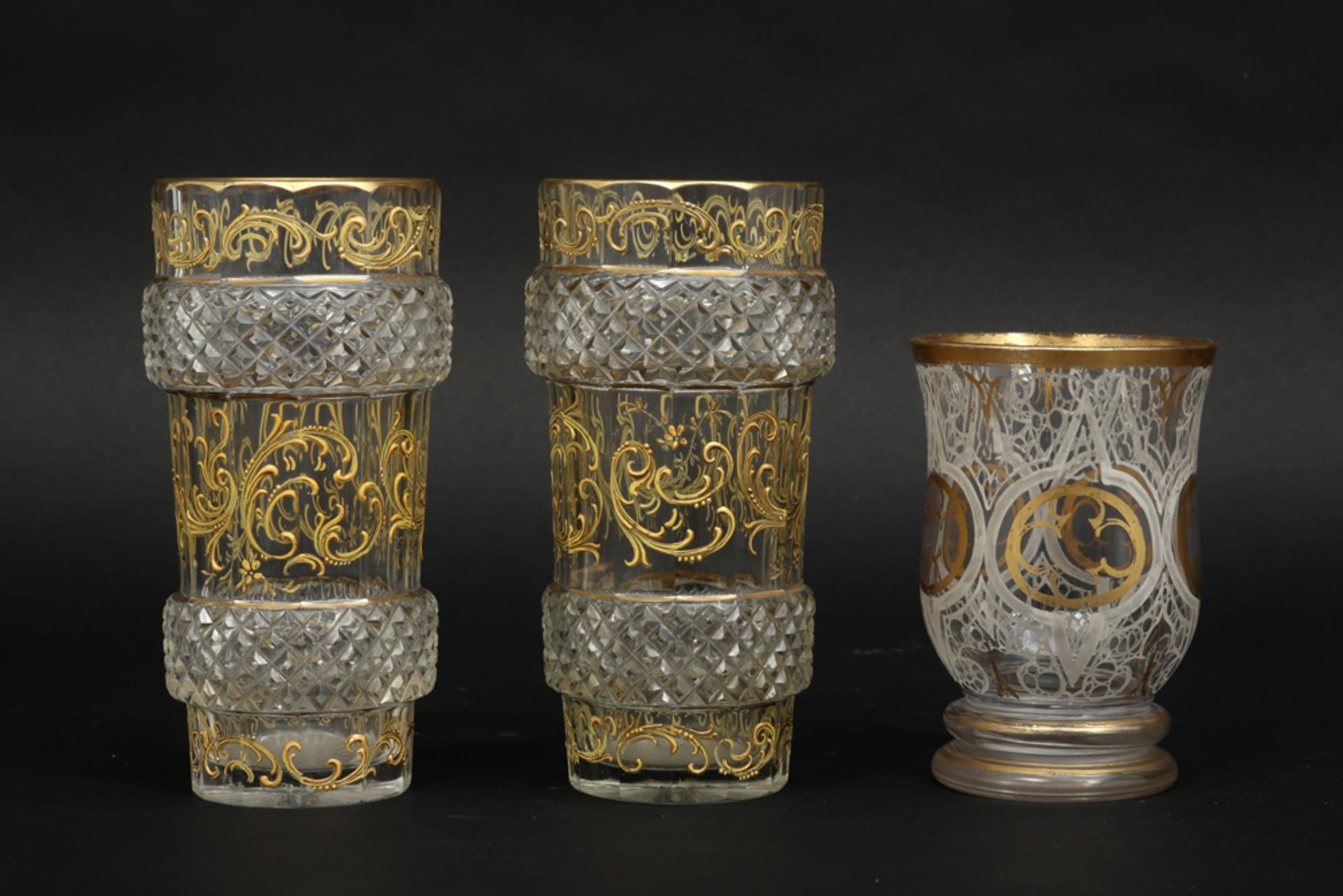 an antique glass and a pair of antique Baccarat vases in crystal, each with a gold decor