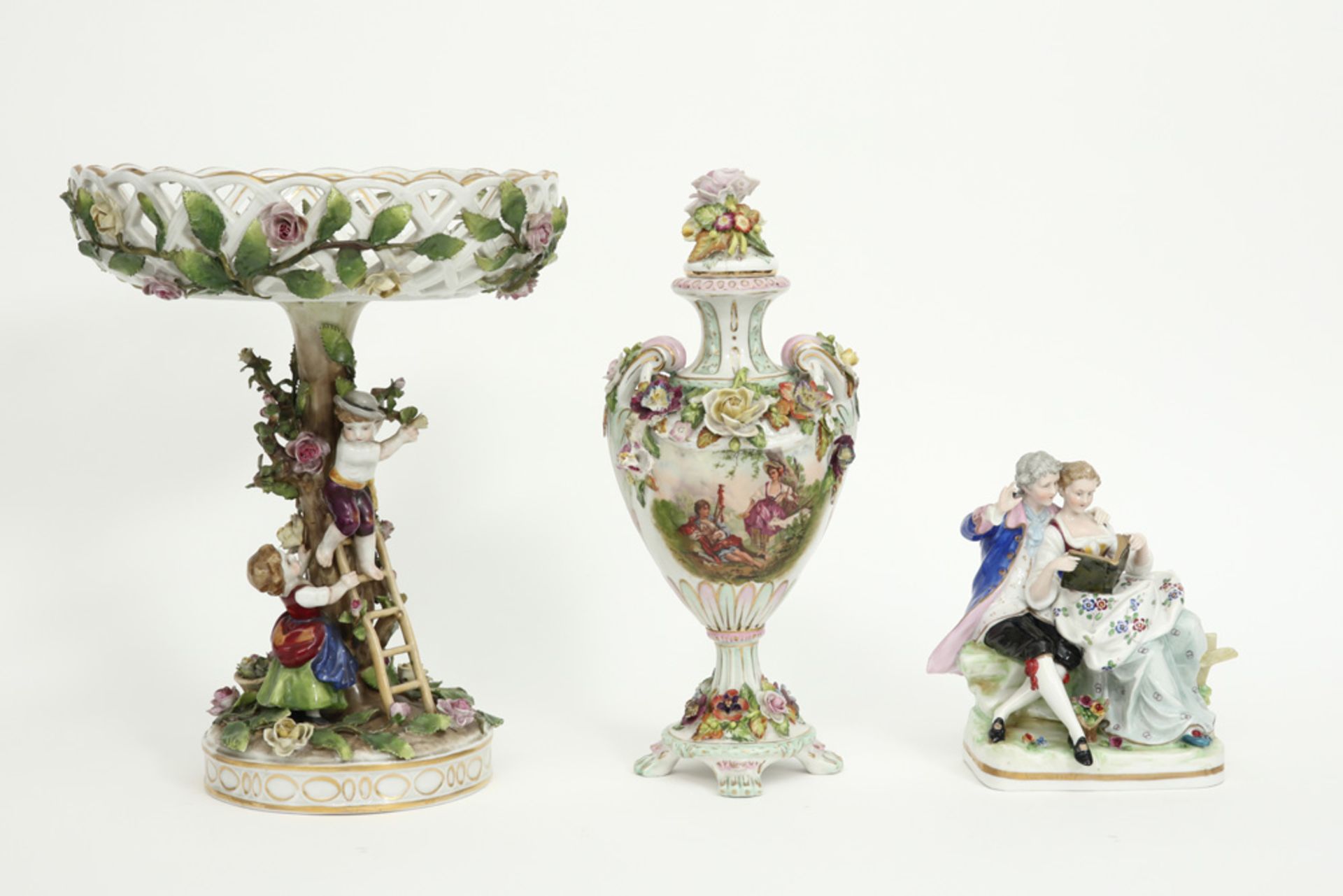 a lidded vase, a group of two figures and a tazza in marked German porcelain
