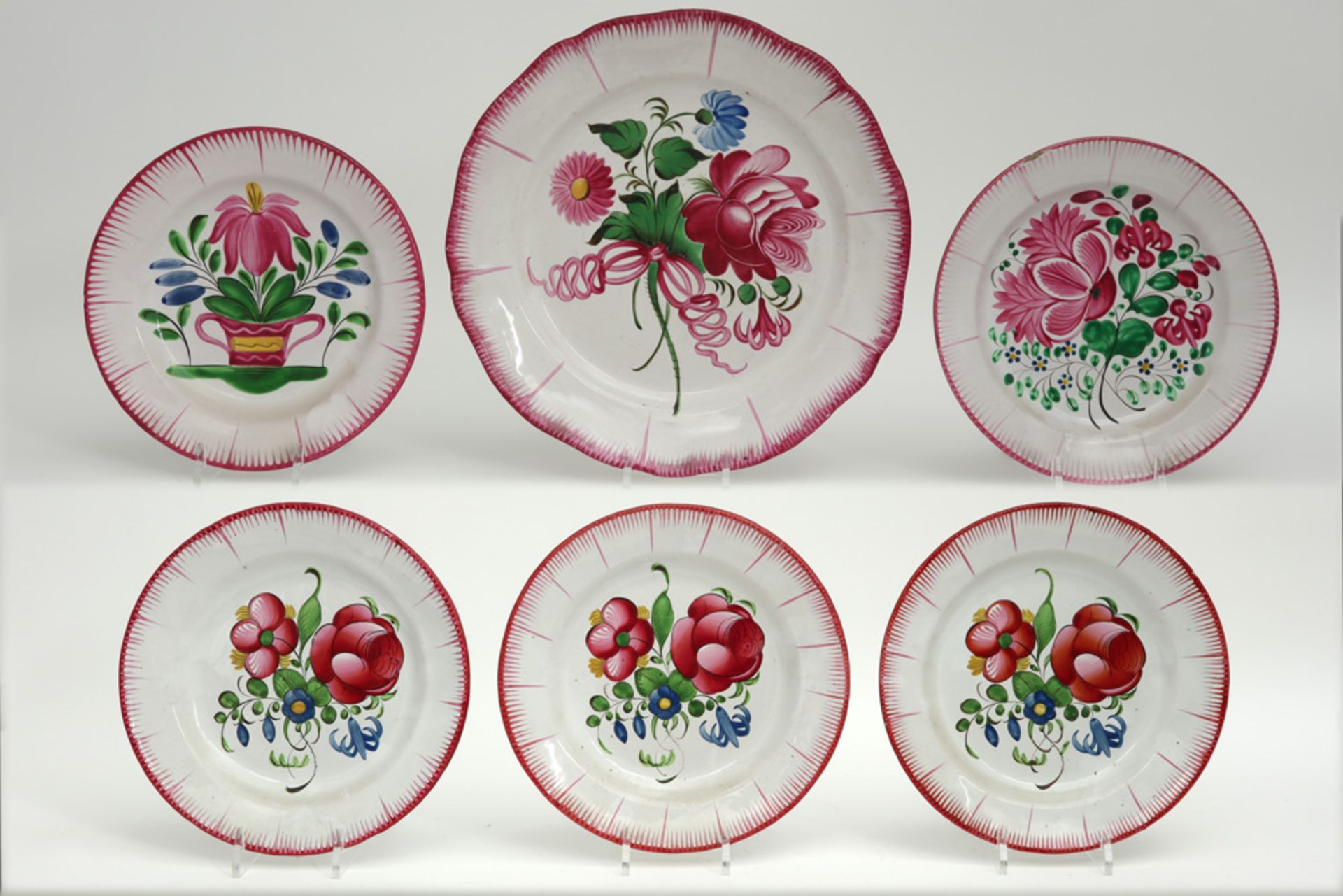 five plates and a serving dish in French ceramic