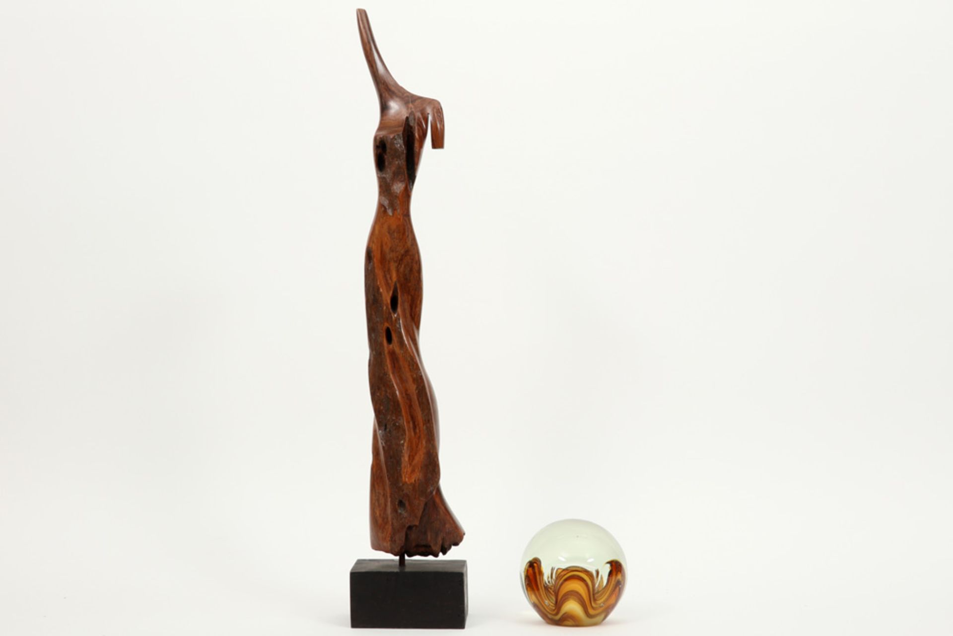sculture in wood and a paperweight in Murano glass