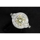 a 0,91 carat high quality fancy yellow brilliant cut diamond set in a ring in white gold (18 carat)