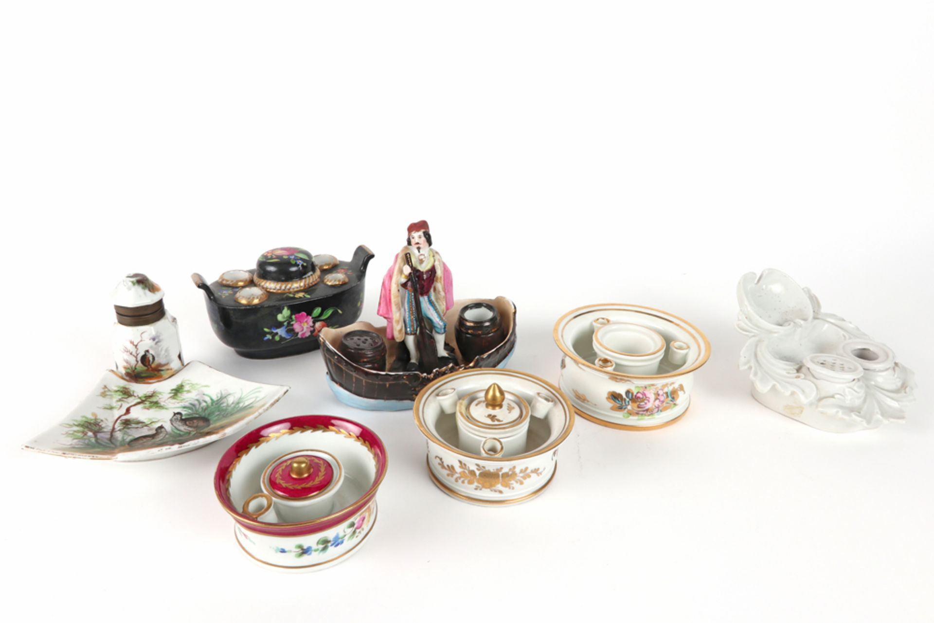 seven antique and old inkstands in porcelain, one with a figure standing in a boat