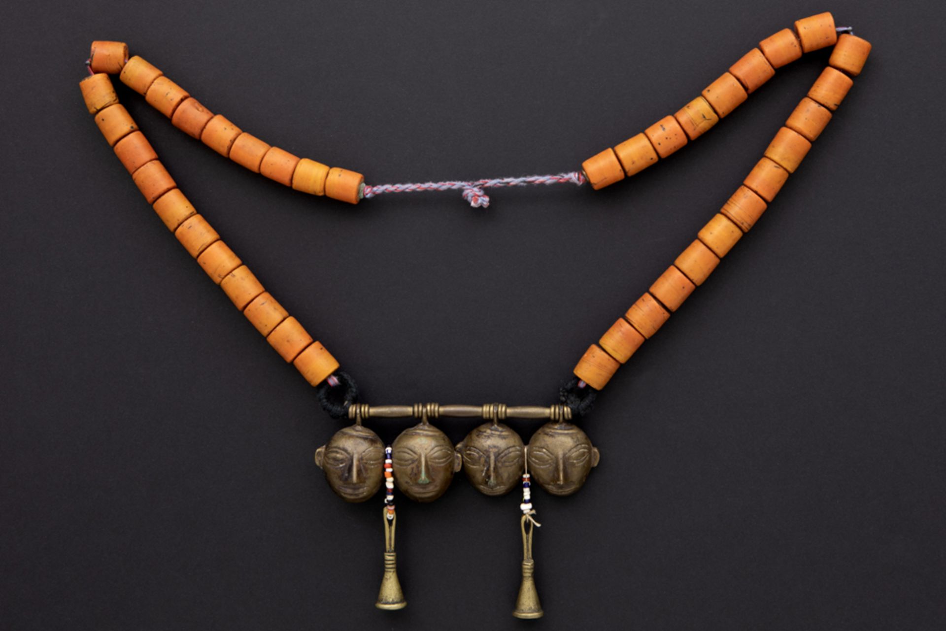 North Indian Naga necklace with beads and a wooden pendant with four bronze heads