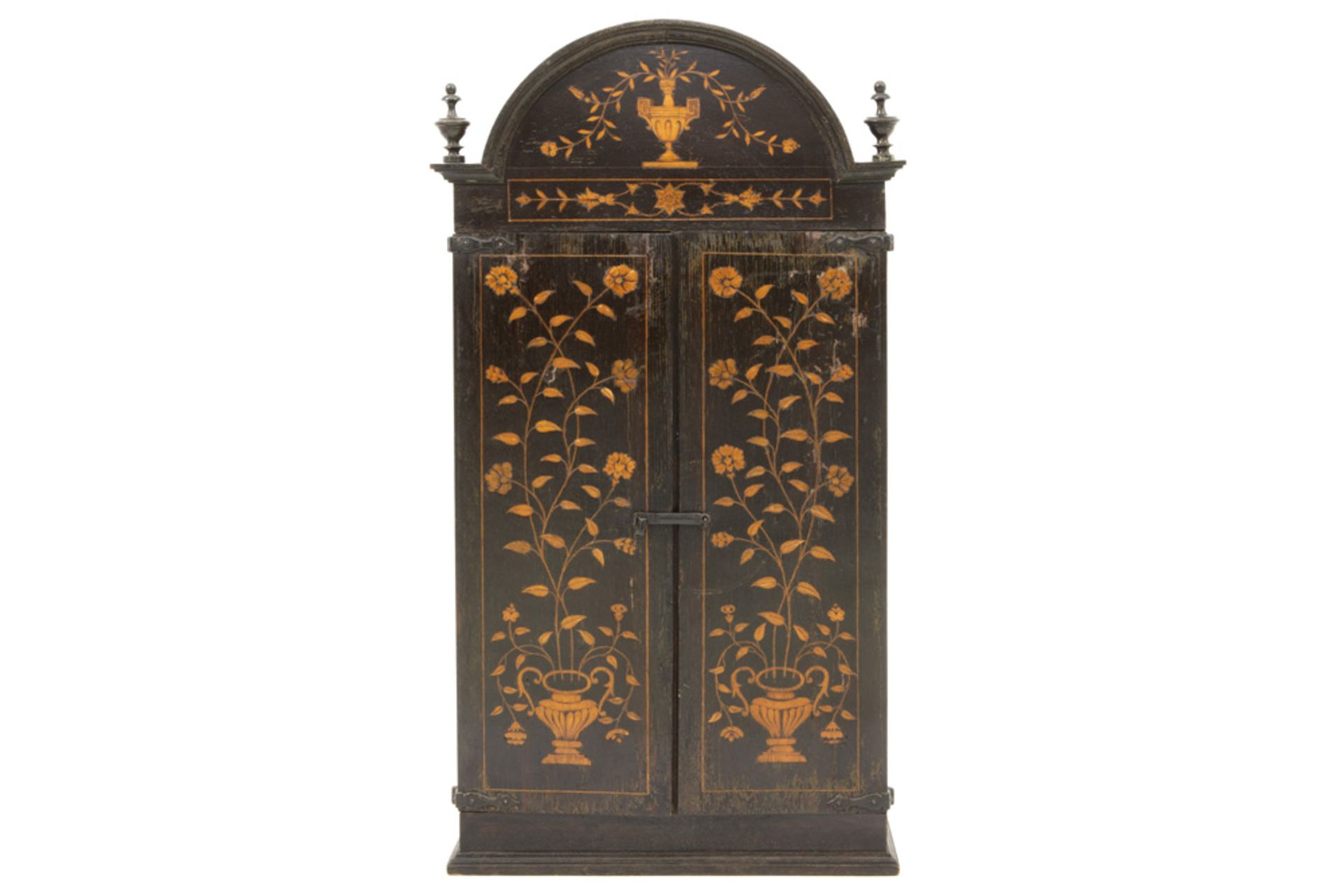 antique altar cabinet in oak with inlaid floral motives and with two doors, which hide a shrine with