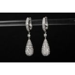 pair of fashionable earrings in white gold (18 carat), each with a ring-shaped earpiece and drop-sha