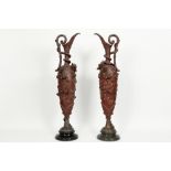pair of antique decorative vases in patinated metal on a marble base