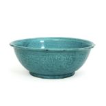 antique Chinese bowl in porcelain with a turquoise glaze with underlying Taotie decor