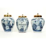 three 18th Cent. ceramic tobacco jars (two are marked) from Delft with a blue-white decor and brass