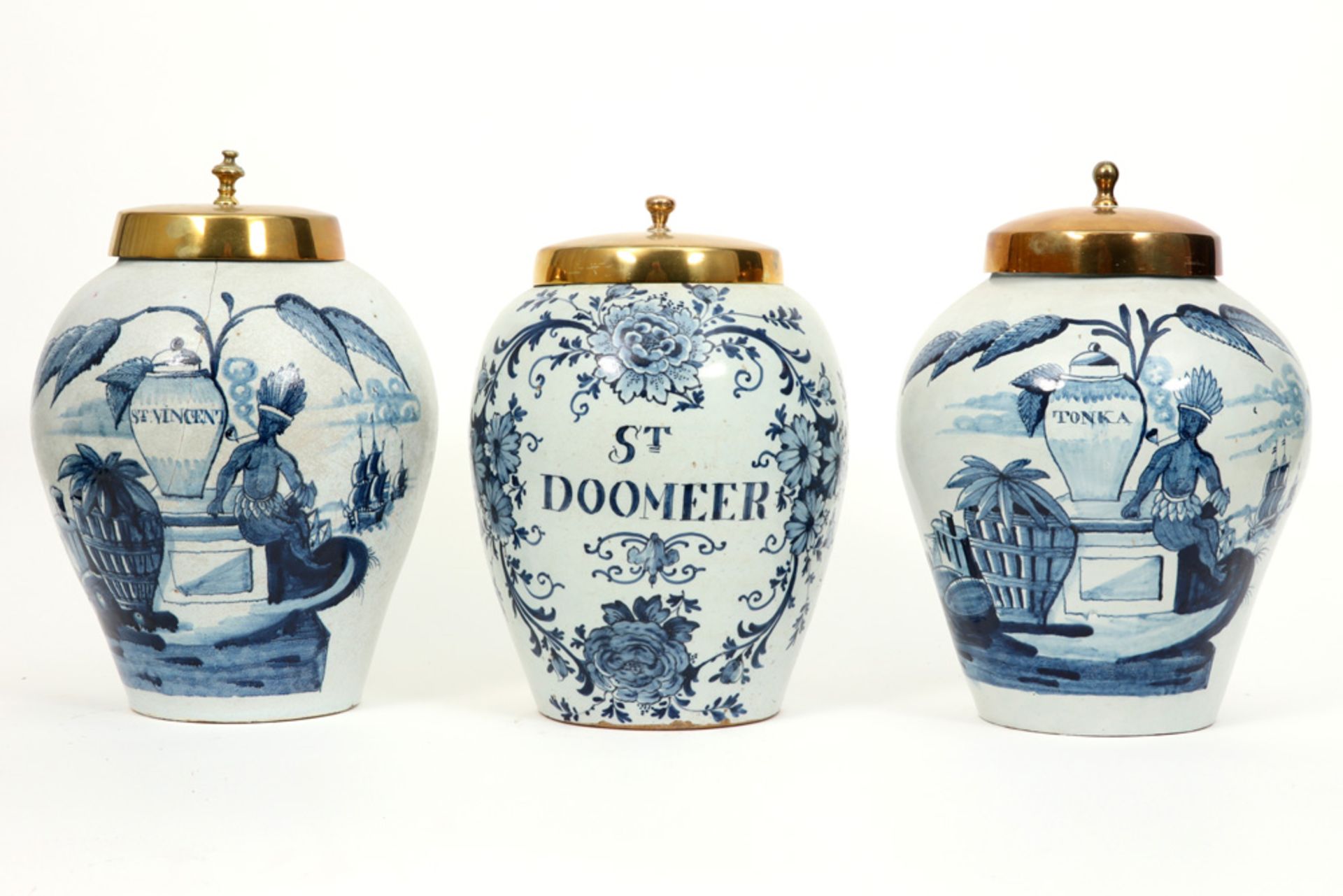 three 18th Cent. ceramic tobacco jars (two are marked) from Delft with a blue-white decor and brass 