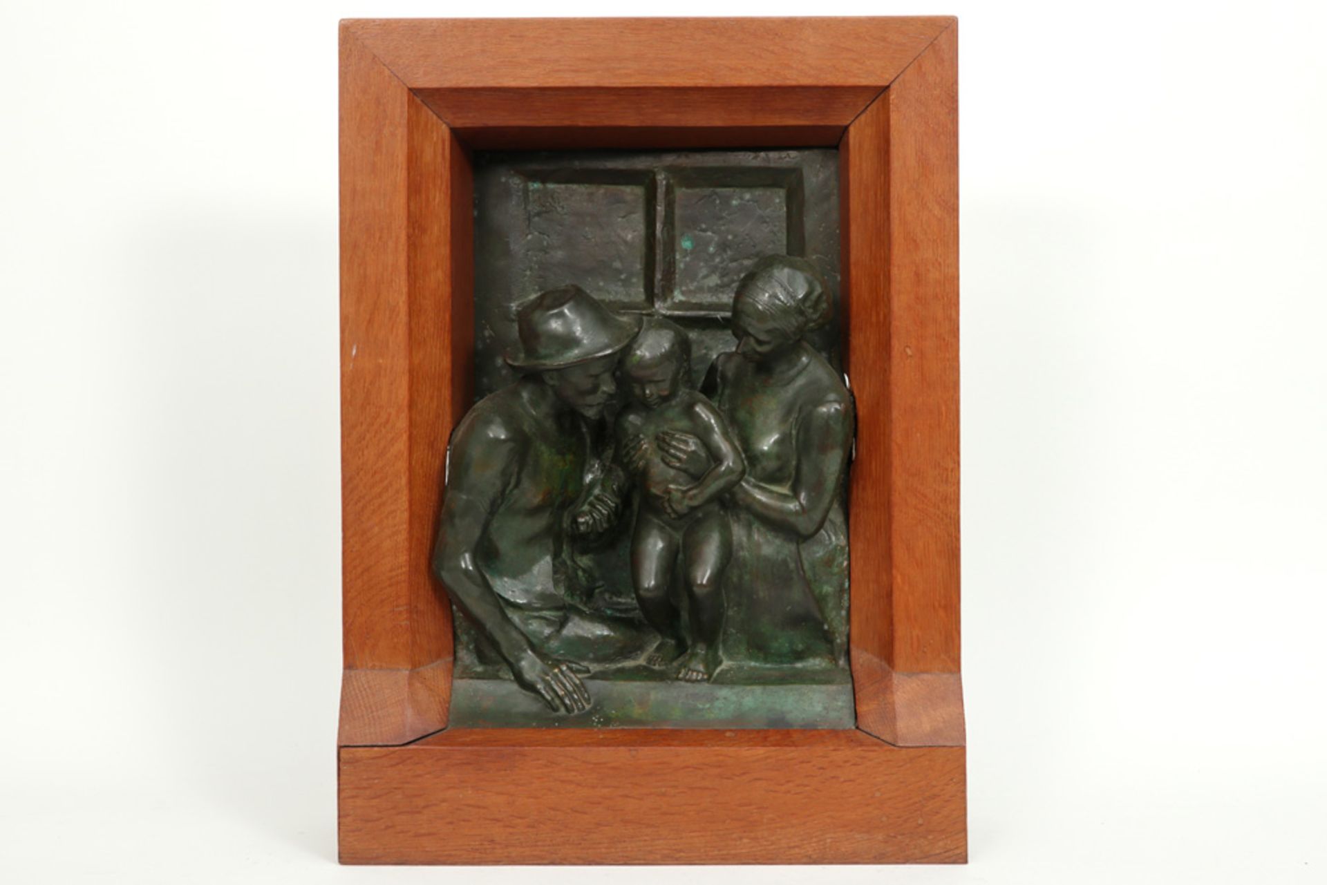 bronze sculpture in high relief with the depiction of a family