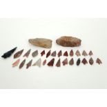 28 Prehistorical stone implements : 2 axes, 25 arrows and a spear point