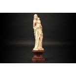 antique European "Holy Mary with grapes and Child" sculpture in ivory - on its wooden base - with