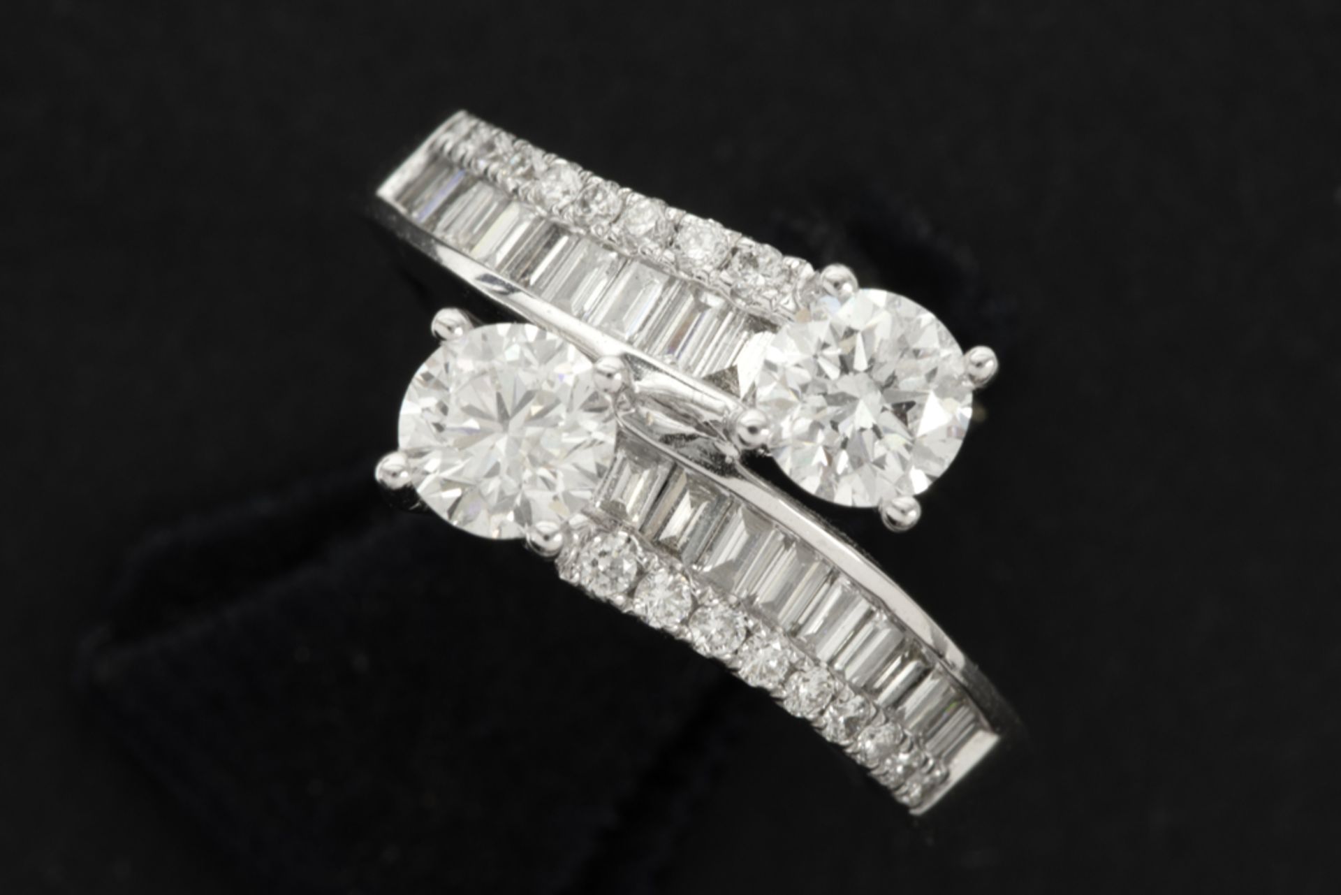 ring in white gold (18 carat) with two bigger brilliants (1,05 carat) and 0,70 carat of small high