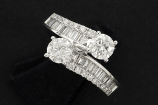 ring in white gold (18 carat) with two bigger brilliants (1,05 carat) and 0,70 carat of small high