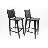 pair of Olivier De Schrijver signed "Kivu" design bar stools in black leather and ebonised mahogany,