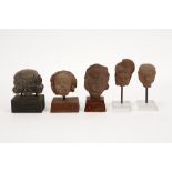 five archaeological finds from the Far East in earthenware, each a fragment (head) of a