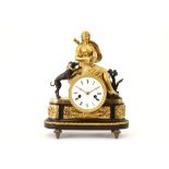 19th Cent. French Empire style clock with case in gilded bronze adorned with a sculpture