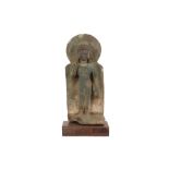 antique Far East stele in partially green oxidised stone with the representation of a deity with a