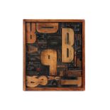 1930's collage with a dadaistic assemblage of wooden printing letters with on the frame a