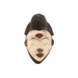 African Gabon Punu-Mukudj mask in wood with typical white color, similar to the mask "L. Bell Fund."