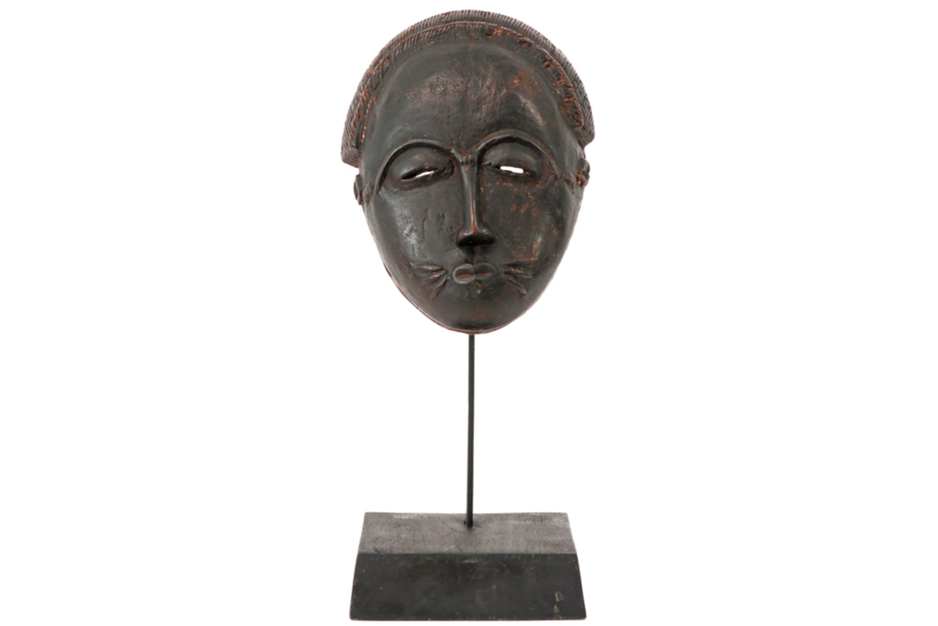 authentic Ivory Coast Baule mask in wood with a cat-like appearance with old patina - on its