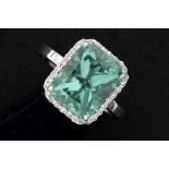 ring in white gold (18 carat) with a central oval apatite of ca 5,50 carat, surrounded by ca 0,20