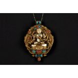 Tibeto Nepalese ghau in yellow gold on silver with turquoise and coral and with the depiction of the