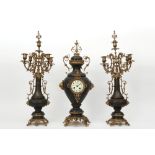 antique brass garniture with a pair of candelabra and a clock with a "F. Marti - Medaille d'Argent