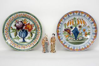 pair of marked dishes and a pair of Chinese style figures in Delft style ceramic with a polychrome