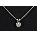 a 0,64 carat fancy light yellow high quality cushion cut diamond set in a pendant in white gold (