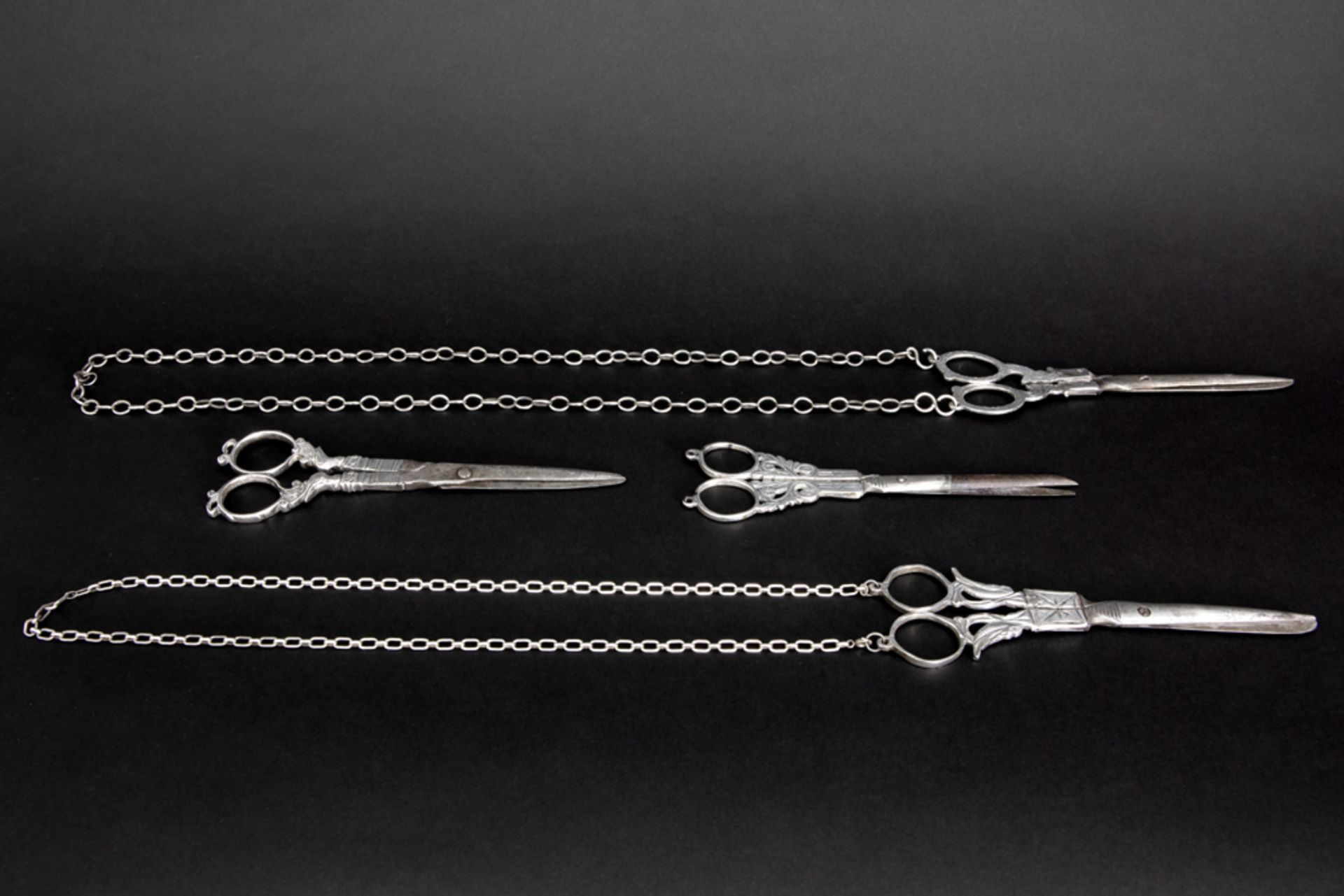four 18th and 19th Cent. scissors, partially in silver, of which two with their original chain ||