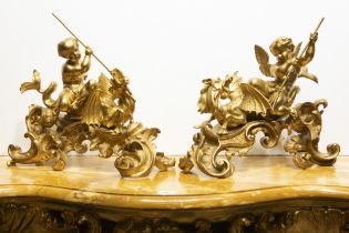 beautiful pair of antique chenets in gilded bronze each with a Cupid and a dragon || Fraai paar