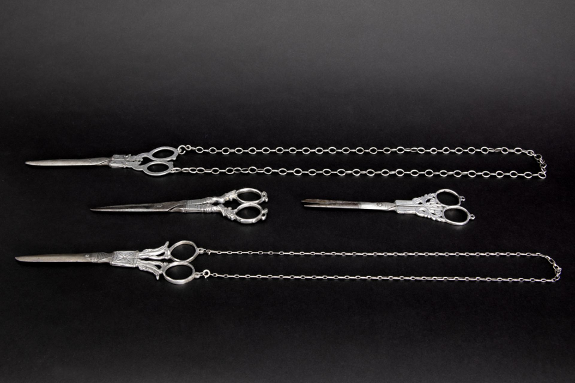 four 18th and 19th Cent. scissors, partially in silver, of which two with their original chain || - Image 2 of 2