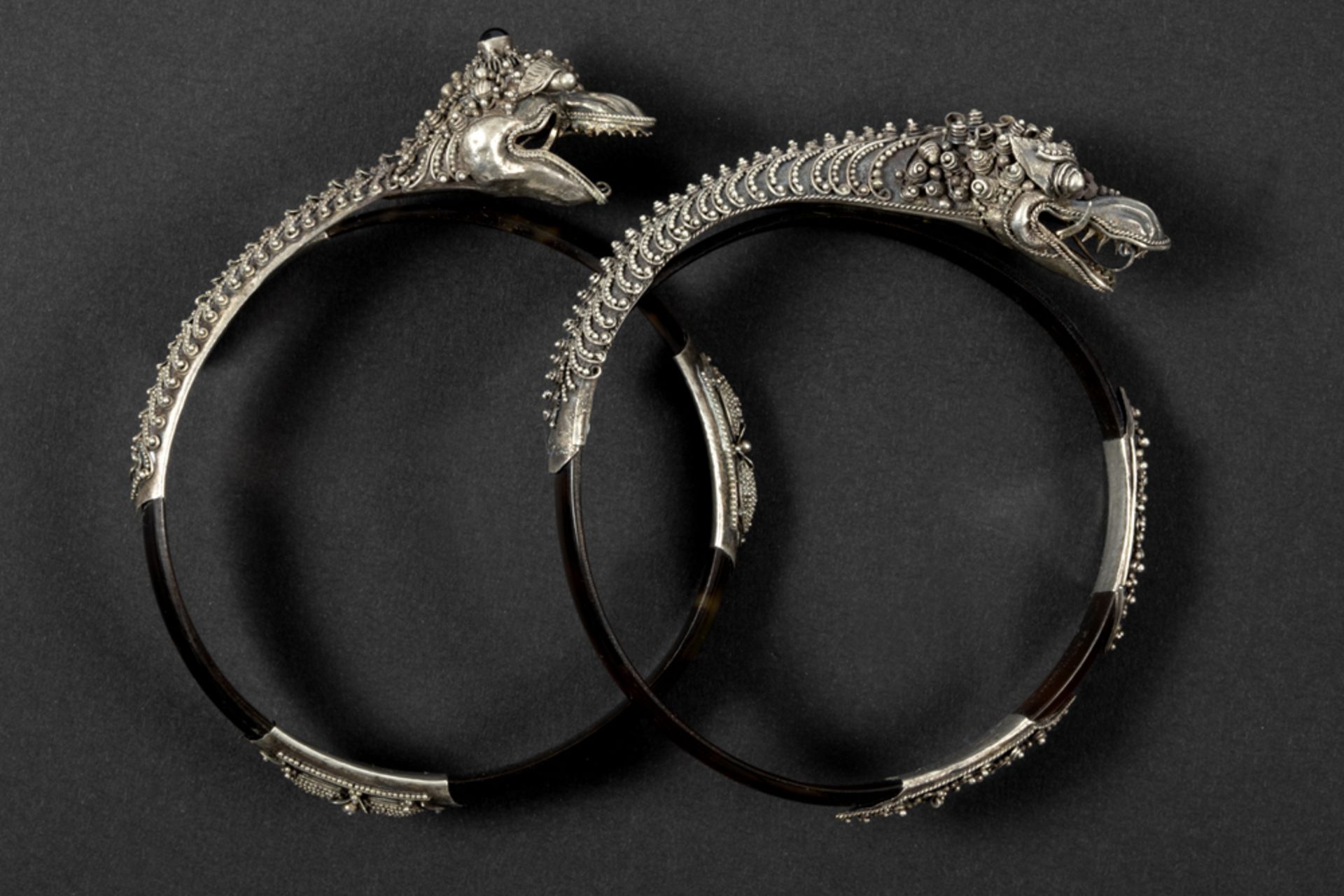 two Far East (presumably Chinese) bangles each with a silver filigrees mounting with dragon's