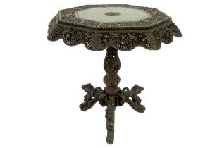 antique oriental-colonial table with fine carvings and with an octagonal top on a base with