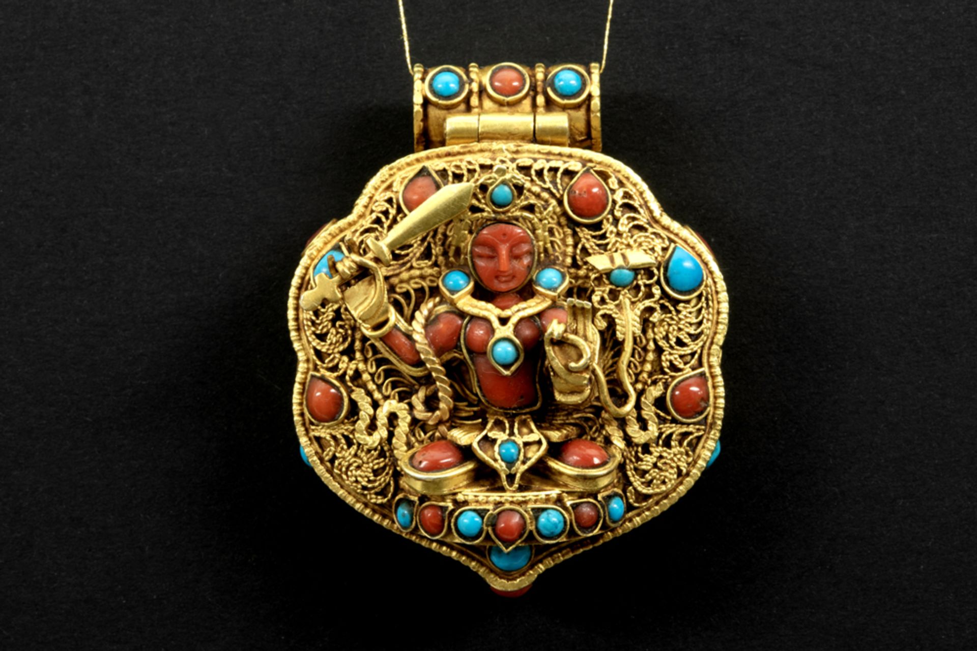 Tibeto Nepalese ghau in yellow gold on silver with turquoise and coral and with on the lid the