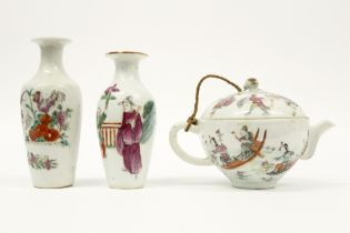 three antique pieces of Chinese porcelain with a polychrome decor : two small vases and a tea pot ||