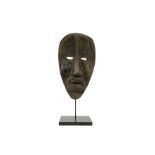 African Ivory Coast beggar's mask of the Dan in wood, which was originally painted black with