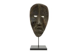 African Ivory Coast beggar's mask of the Dan in wood, which was originally painted black with