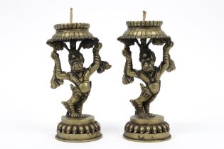 pair of vintage Nepalese temple candlesticks in a copper alloy with a dancing mythical animal ||