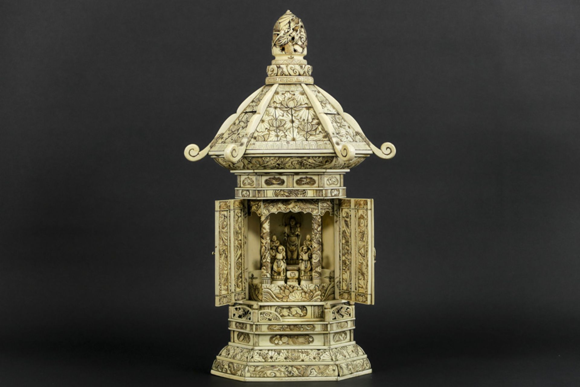 antique quite big Chinese house altar in carved ivory with a shrine with two doors hiding Boeddha