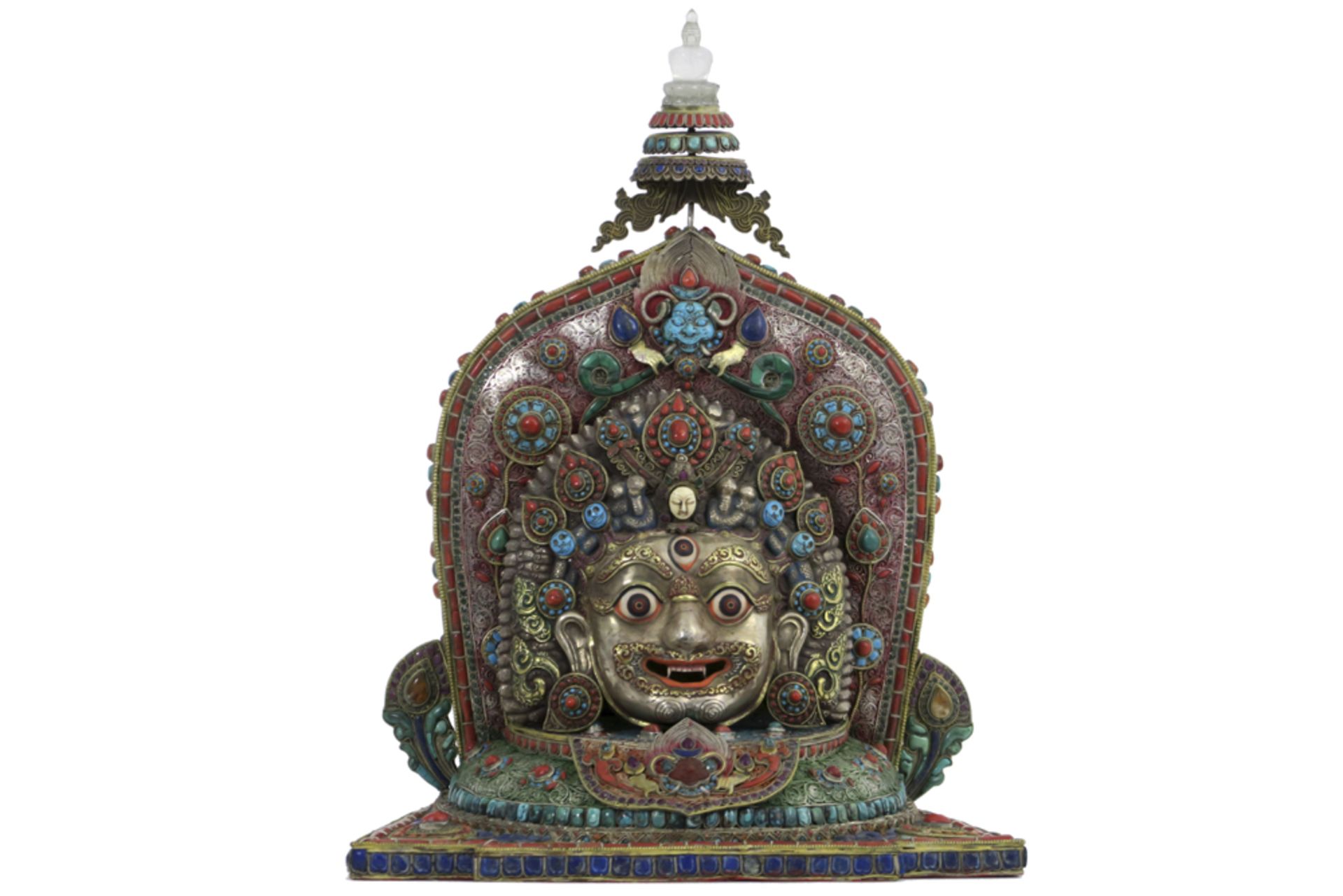 very nice old Nepalese house temple sculpture with a "Bhairava" mask - in silver, adorned with