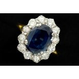 nice vintage ring in yellow and white gold (18 carat) with an at least 5 carat sapphire surrounded