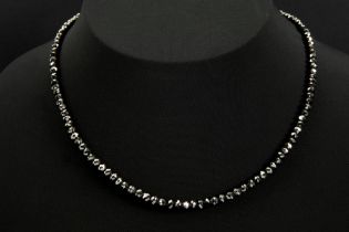 classy necklace with one row of facetted high quality black diamond beads and with a lock in white