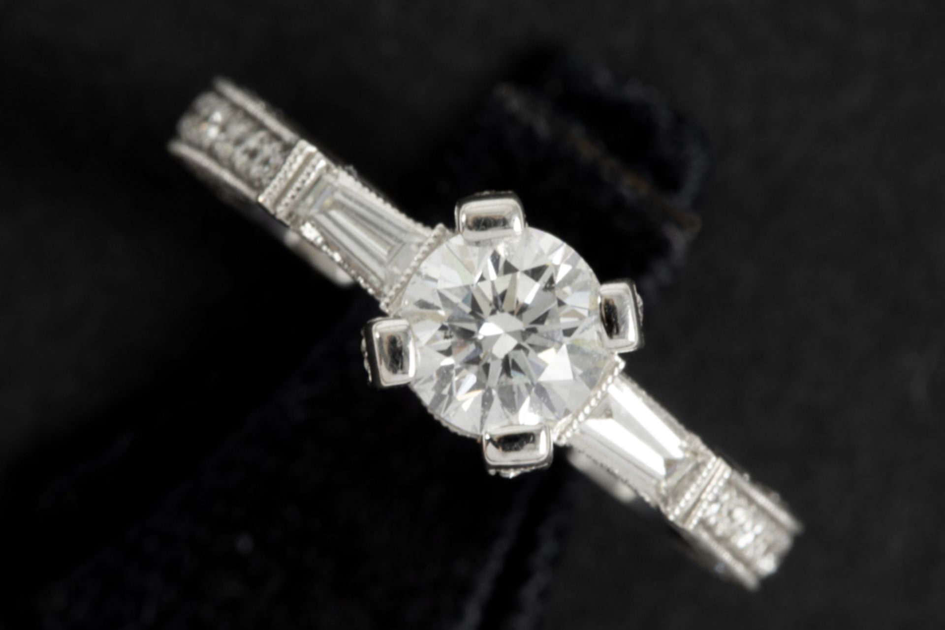 a 0,80 carat high quality brilliant cut diamond set in a ring in white gold (18 carat) with more