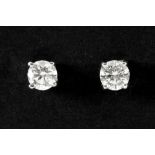 pair of earrings in white gold (18 carat), each with one diamond of ca 0,75 carat - in total : at